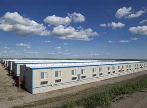 AP Photo/Gregory BullA man walks back to his temporary housing unit outside of Williston, N.D. With what many are calling the largest oil boom in recent North American history, temporary housing for the huge influx of workers, known as man camps, now dot the sparse North Dakota landscape.