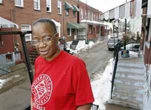 AP Photo/Keith SrakocicSharon Edge stands by the house in Pittsburgh last month where she and her late boyfriend, Curtis Mitchell, lived.
