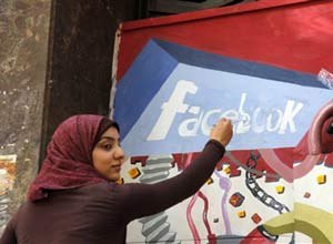 AP Photo/Manoocher DeghatiAn art student from the University of Helwan paints the Facebook logo on a mural commemorating the revolution that overthrew Hosni Mubarak. Dave Konig argues that you can either be like the Egyptian protesters who embraced and used social media, or the leadership that ignored it.