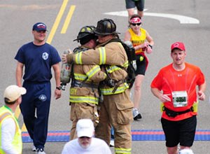 Photo Matthew McNabbRichard Lawrence and Brian Christy embrace during the marathon.