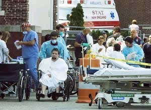 AP Photo/The Standard Times, Andrew T. GallagherMedical personnel tend to people outside St. Luke's Hospital on Monday.