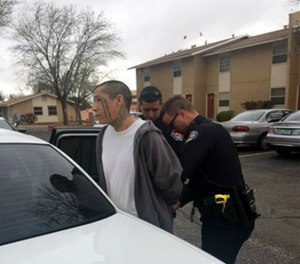 This photo provided by the Albuquerque Police Department shows Lionel Clah being taken into custody by Albuquerque police Saturday, March 12, 2016. (AP Image)
