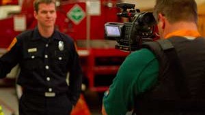 Director and Producer Ted Setla, right, films Schorr in the San Francisco Fire Department headquarters on Sunday.