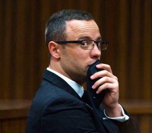 In this photograph taken on Tuesday, May 19, 2014, Oscar Pistorius listens to psychiatric evidence for his defense, during his ongoing murder trial in Pretoria, South Africa. (AP Photo/Daniel Born, Pool, File)