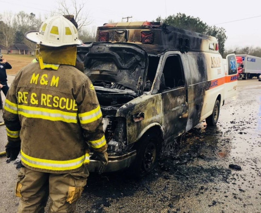 The ASAP Ambulance Service vehicle was driving down the highway when a fire broke out in the engine compartment.