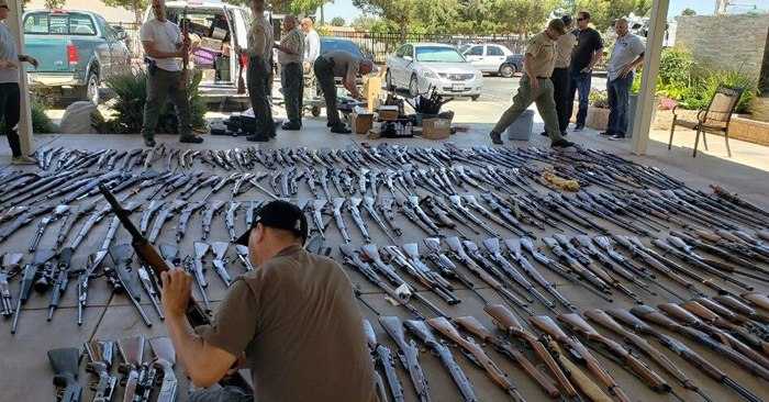 Authorities line up the hundreds of seized firearms.