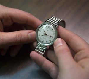In this Feb. 26, 2016, photo, Allison Rice, whose father was a white-collar criminal and died in prison of cancer without being granted compassionate release, holds her father's watch. (AP Image)
