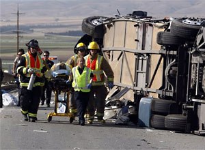 AP Photo/The Monterey County Herald, Vern FisherFirefighters transport an injured passenger at the scene, Tuesday.