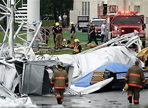 AP Photo/Matt Slocum Firefighters investigate the collapsed canopy.