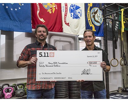 Driessen and 5.11 CEO, Tom Davin,  holding the $20,000 check for Navy SEAL Foundation