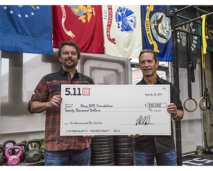 Driessen and 5.11 CEO, Tom Davin, holding the $20,000 check for Navy SEAL Foundation