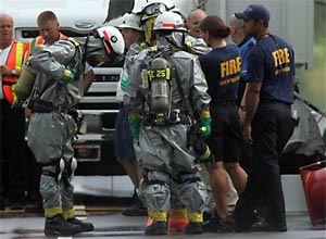 AP Photo/Jim R. Bounds, PoolRescue workers gather at the food plant after the explosion Tuesday.