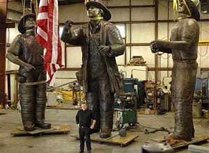 AP Photo/Fred Hayes, File Sculptor Stan Watts stands in front of his bronze sculptures.