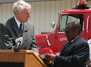 Photo Milwaukee Fire DepartmentMayor Barrett gives the title for the fire engine to Tanzanian Ambassador to the U.S., Ombeni Sefue.