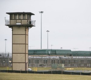 In this Feb. 1, 2017, file photo, a CO stands on a tower during a hostage situation at James T. Vaughn Correctional Center in Smyrna, Del. (Suchat Pederson/The News Journal via AP)