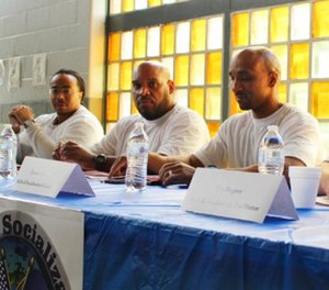In this June 27, 2017 photo prison inmates Tarrance Lawrence, Ray Boyd and Tino Negron prepare talk a group of federal judges visiting the Osborn Correctional Institution in Somers, Conn. about the Skills of Socialization program. (AP Photo/Pat Eaton-Robb)