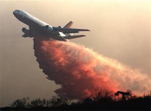 AP Photo/John LazarA DC-10 drops fire retardant over a hillside to battle wildfires in Grimes Canyon in Fillmore, Calif., on Tuesday.