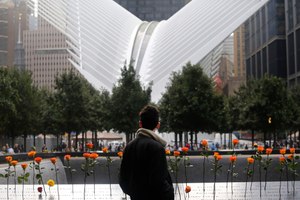 A man looks at the North Pool at the World Trade Center during a ceremony marking the 17th anniversary of the terrorist attacks on the United States. Tuesday, Sept. 11, 2018, in New York. In the background is the World Trade Center Transportation Hub. (AP Photo/Mark Lennihan)