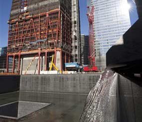 Streams of water pour over the edge of a National September 11 Memorial pool during a test of the waterfalls, Tuesday, Nov. 9, 2010 at the World Trade Center site in New York. The two memorial pools, which are scheduled to be open to the public in September, 2011, reflect the location of the original twin towers.