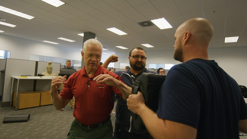 Sandy Wall instructs participants on self defense moves.