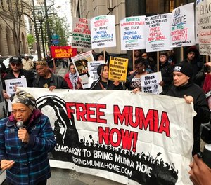 Supporters of Mumia Abu-Jamal, convicted in the 1981 murder of white Philadelphia police Officer Daniel Faulkner, gather outside the Criminal Justice Center in Center City Philadelphia on Monday, April 30, 2018. (Jessica Griffin/The Philadelphia Inquirer via AP)