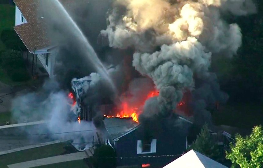 In this image take from video provided by WCVB in Boston, firefighters battle a raging house fire in Lawrence, Mass, a suburb of Boston, Thursday, Sept. 13, 2018. Emergency crews are responding to what they believe is a series of gas explosions that have damaged homes across three communities north of Boston. (WCVB via AP)