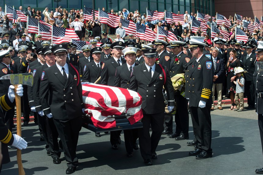 FIn this Aug. 20, 2018, file photo, the casket with fallen Utah firefighter Matthew Burchett is loaded into a fire engine after the funeral at the Maverik Center in West Valley City, Utah. Burchett, a firefighter battling the largest wildfire in California history, was killed last month when thousands of gallons of flame-suppressing liquid were dropped from a Boeing 747 that was mistakenly flying only 100 feet (30 meters) above the treetops, according to an official report Friday, Sept. 14.