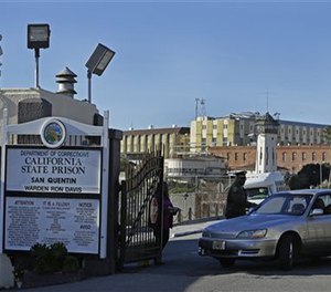 In this Dec. 29, 2015 file photo, a guard checks identification of a person leaving the east gate of San Quentin State Prison. (AP Image)