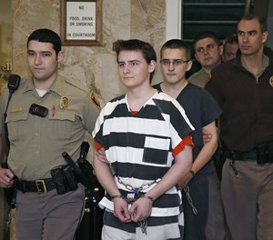 In this Tuesday, Feb. 23, 2016 file photo, two Oklahoma teenage brothers are escorted into a courtroom for a hearing in Tulsa, Okla. (AP Photo/Sue Ogrocki, File)