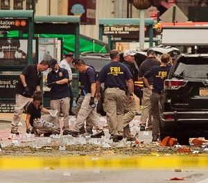 In this Sunday, Sept. 18, 2016 file photo, members of the Federal Bureau of Investigation (FBI) carry on investigations at the scene of Saturday's explosion on West 23rd Street and Sixth Avenue in Manhattan's Chelsea neighborhood, in New York.