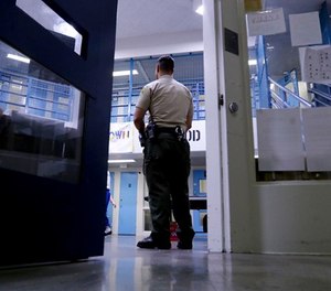 A Sheriff officer stands guard over inmates at the Twin Towers Correctional Facility Thursday, April 27, 2017, in Los Angeles.