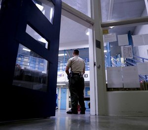 A Sheriff officer stands guard over inmates at the Twin Towers Correctional Facility Thursday, April 27, 2017, in Los Angeles. (AP Photo/Chris Carlson)