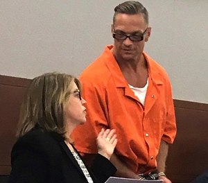 In this Aug. 17, 2017, file photo, Nevada death row inmate Scott Dozier, right, confers with Lori Teicher, a federal public defender involved in his case, during an appearance in Clark County District Court in Las Vegas.