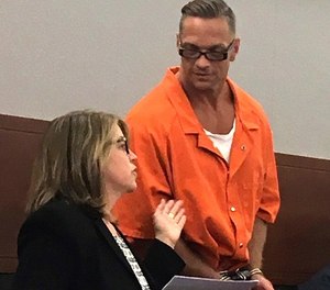 In this Aug. 17, 2017 file photo, Nevada death row inmate Scott Raymond Dozier confers with Lori Teicher, a federal public defender involved in his case, during an appearance in Clark County District Court in Las Vegas.