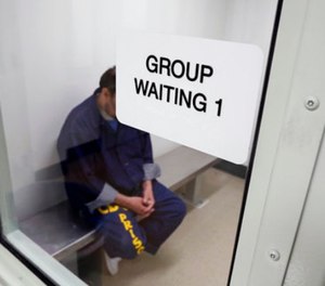An inmate waits for his appointment in a holding room at a mental health treatment unit. (Rich Pedroncelli, File via AP)