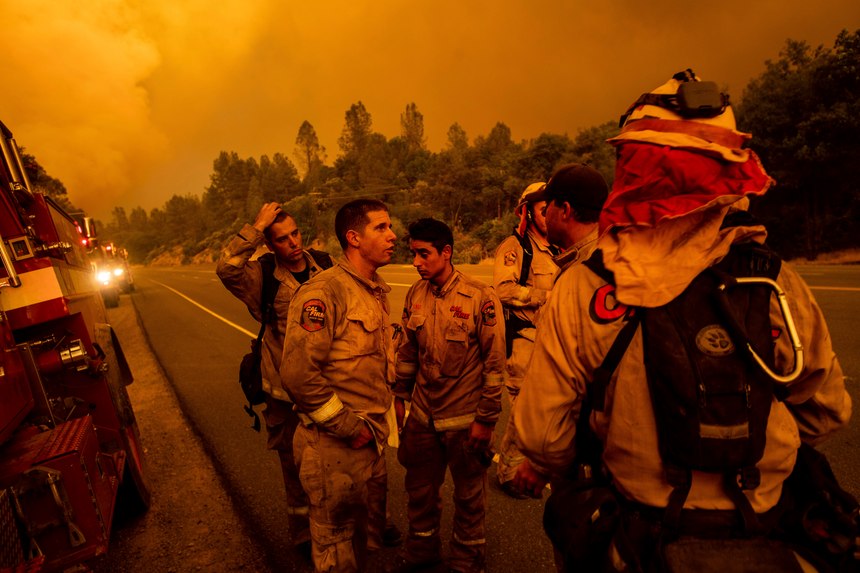 Firefighters discuss plans while battling the Carr Fire in Shasta, Calif., on Thursday, July 26, 2018.