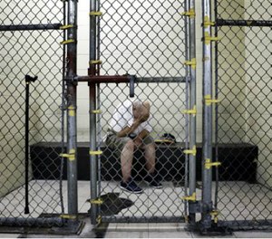 In this June 26, 2014 file photo, a U.S. veteran with post-traumatic stress sits in a segregated holding pen at the Cook County Jail after he was arrested on a narcotics charge in Chicago. (AP Image)
