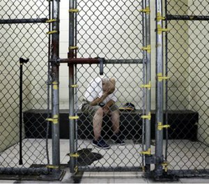 In this June 26, 2014 file photo, a U.S. veteran with post-traumatic stress sits in a segregated holding pen at the Cook County Jail after he was arrested on a narcotics charge in Chicago. (AP Image)