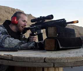 In this Dec. 23, 2012 file photo, Michael Reed, of Cedar Park, Texas, shoots an AR-15 rifle, at Dragonman's firing range and gun dealer.
