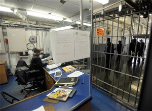 In this Nov. 14, 2013 file photo, a corrections officer works at a security post at Baltimore City Detention Center in Baltimore.