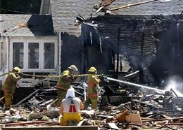 Firefighters work at a destroyed home after a natural gas explosion in Carlinville, Ill., in August last year when two people died.