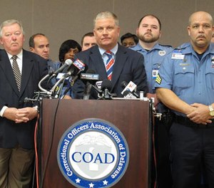 Geoffrey Klopp, center, president of the Correctional Officers Association of Delaware, speaks about a prison uprising Thursday, Feb. 2, 2017, in Dover, Del. Klopp says that he believes the uprising was due to low staffing issues at the 2,500-prisoner James T. Vaughn Correctional Center that have existed for years. (AP Photo/Brian Witte)