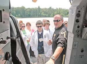 Photo courtesy of The Mount Airy NewsScott Schroat, a paramedic with AirCare, shows students the inside of the helicopter during Camp Med at Surry Community College in Dobson, N.C., on Wednesday.
