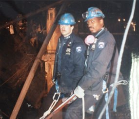 Corey Cuneo (left), with his good friend Sgt. Rodney Gillis, in the immediate aftermath of the first World Trade Center attack in 1993. They are standing beside the three-story crater left by the VBIED which rocked the building one cold February morning. Sgt. Gillis would become one of the 23 NYPD officers perish during the 9/11 attacks. (Photo courtesy of Corey Cuneo) 
