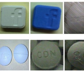 The image above, distributed by Service de police de la Ville de Montréal (SPVM), shows seized drugs bearing copycat “branding” imprints such as Facebook in an effort to market the drug to young people. (PoliceOne Image)