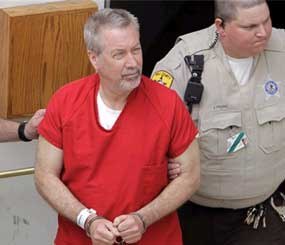 In this May 8, 2009 file photo, former Bolingbrook, Ill., police sergeant Drew Peterson leaves the Will County Courthouse in Joliet, Ill., after his arraignment on charges of first-degree murder in the 2004 death of his former wife Kathleen Savio.