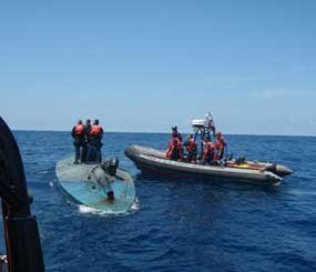 The crew of the U.S. Coast Guard Cutter Jarvis and other U.S. law enforcement agency officials detain a man on a self-propelled semi-submersible vessel during an intercept and seizure in the international waters of the Eastern Pacific off the coast of Guatemala. Guatemalan Defense Ministry spokesman Col. Byron Gutierrez said the semi-sub was detected by Guatemalan personnel operating jointly with the U.S. Drug Enforcement Administration. An undetermined amount of cocaine was seized and the crew of the semi-sub was taken into custody.