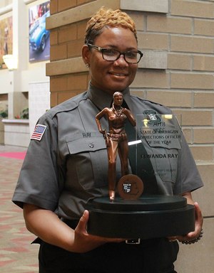 Michigan Corrections Officer of the Year Elwanda Ray with her customized award from Michigan Corrections Organization.