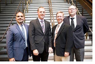Amit Kapoor, President and CEO of First Line Technology (far left), Michael Corle, Product Manager DeconTect (left), Chris Hodge (right) and Tony Buhr (far right) of Naval Surface Warfare Center, Dahlgren Division accept the 2018 Excellence in Technology Transfer Award for Dahlgren Decon at the Federal Laboratory Consortium Awards Dinner in Philadelphia, Pennsylvania, April 25, 2018.