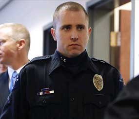 Aurora Police Officer Justin Grizzel leaves court after testifying at a preliminary hearing for James Holmes at the courthouse in Centennial, Colo., on Monday, Jan. 7.
